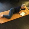 A woman laying on the floor with her feet up.