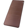 A brown mat is laying on the floor.